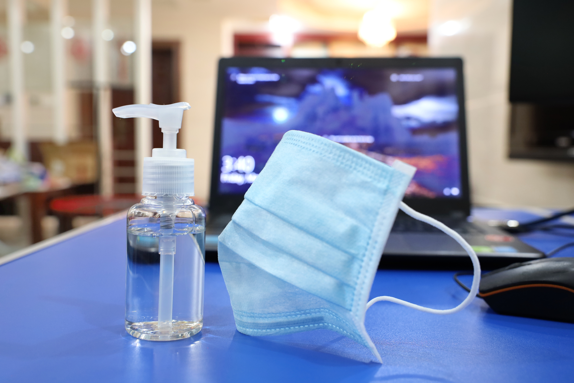 computer with mask and hand sanitizer