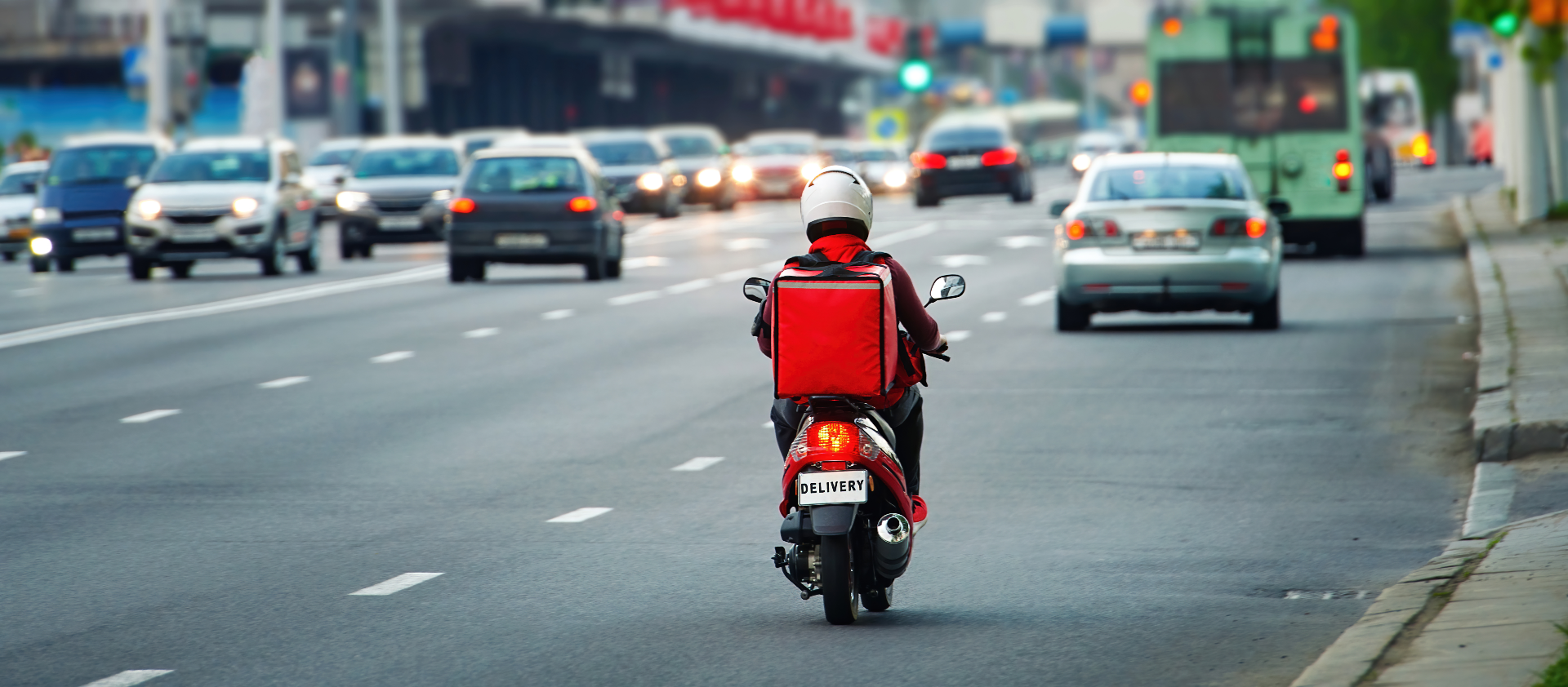 Food delivery driver on red scooter