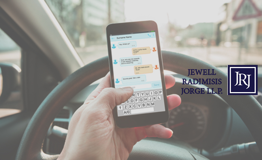 Person on phone while driving car steering wheel