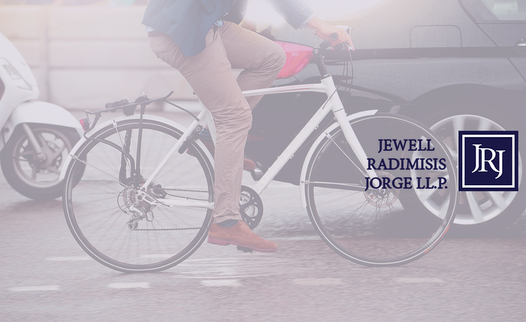 person riding bicycle through traffic