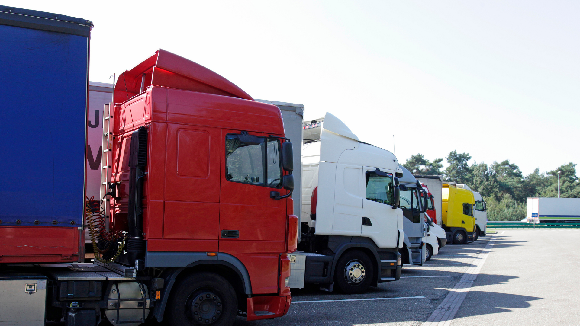 semi trucks lined up in a parking lot