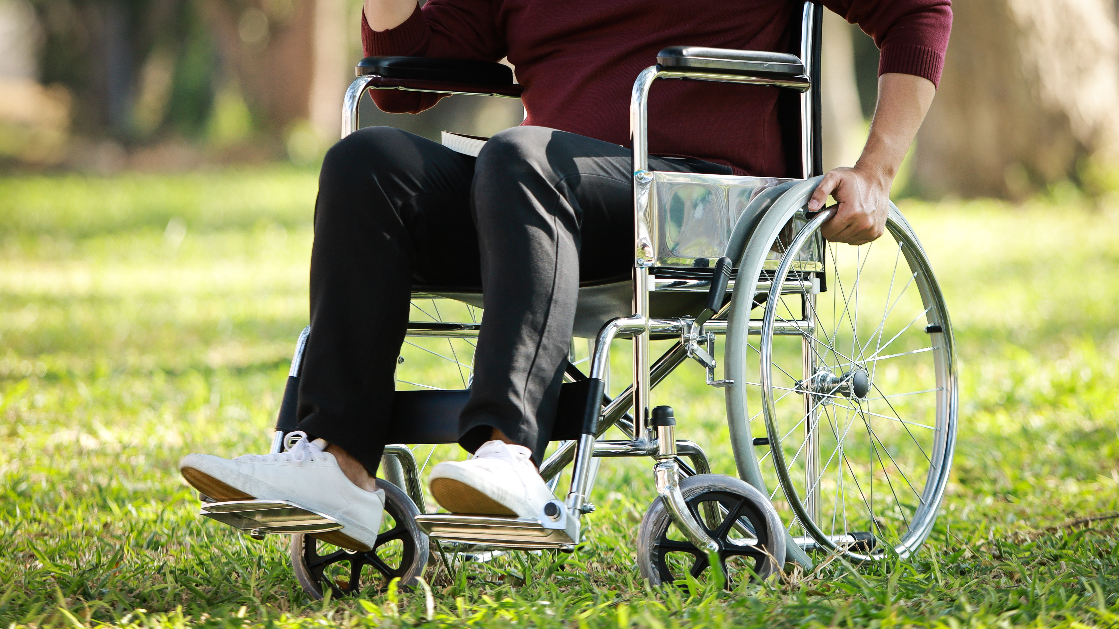 Torso and Legs of a Man in a Wheelchair Outside