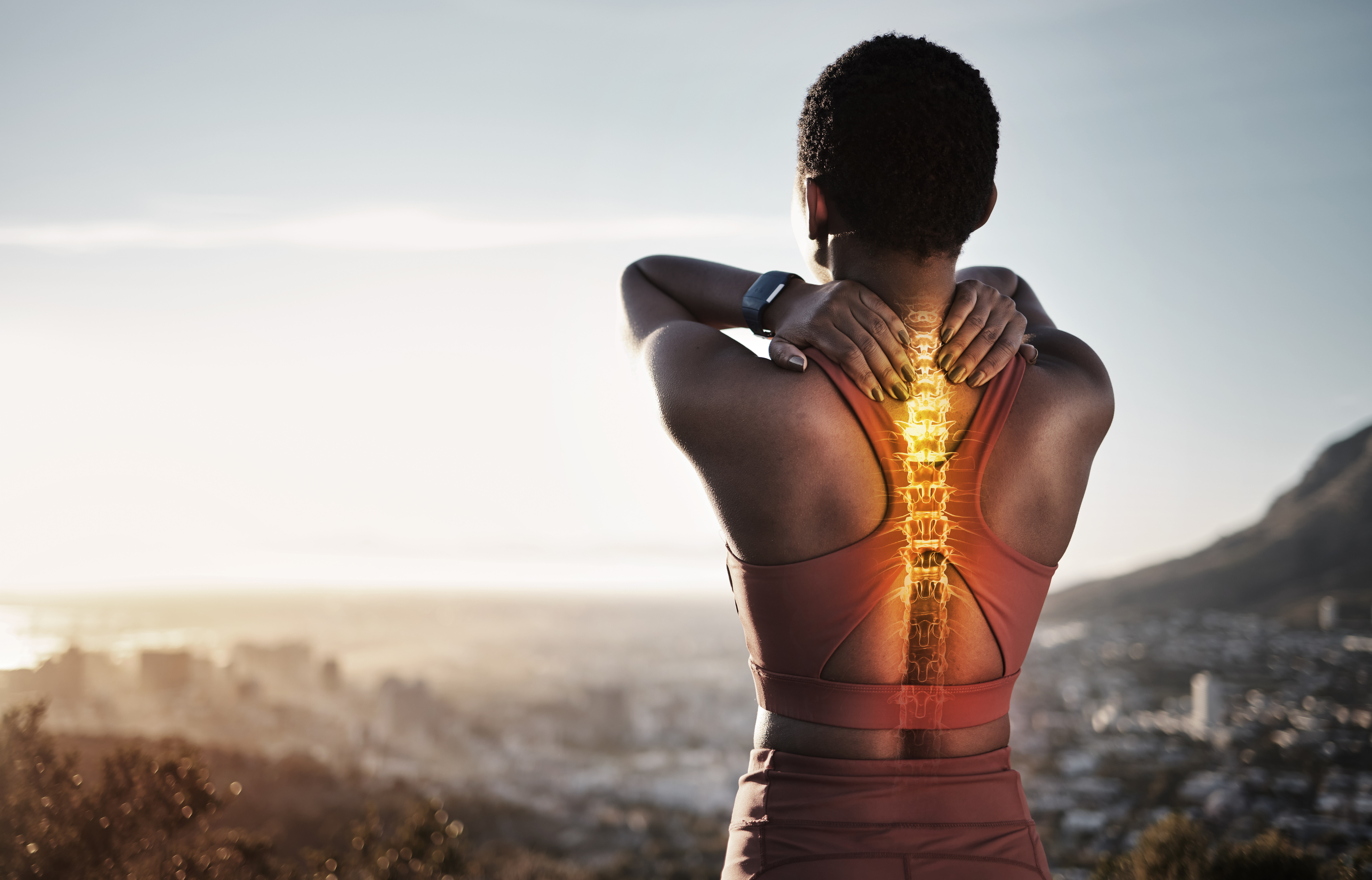 Woman Holding Shoulders With Glowing Spine