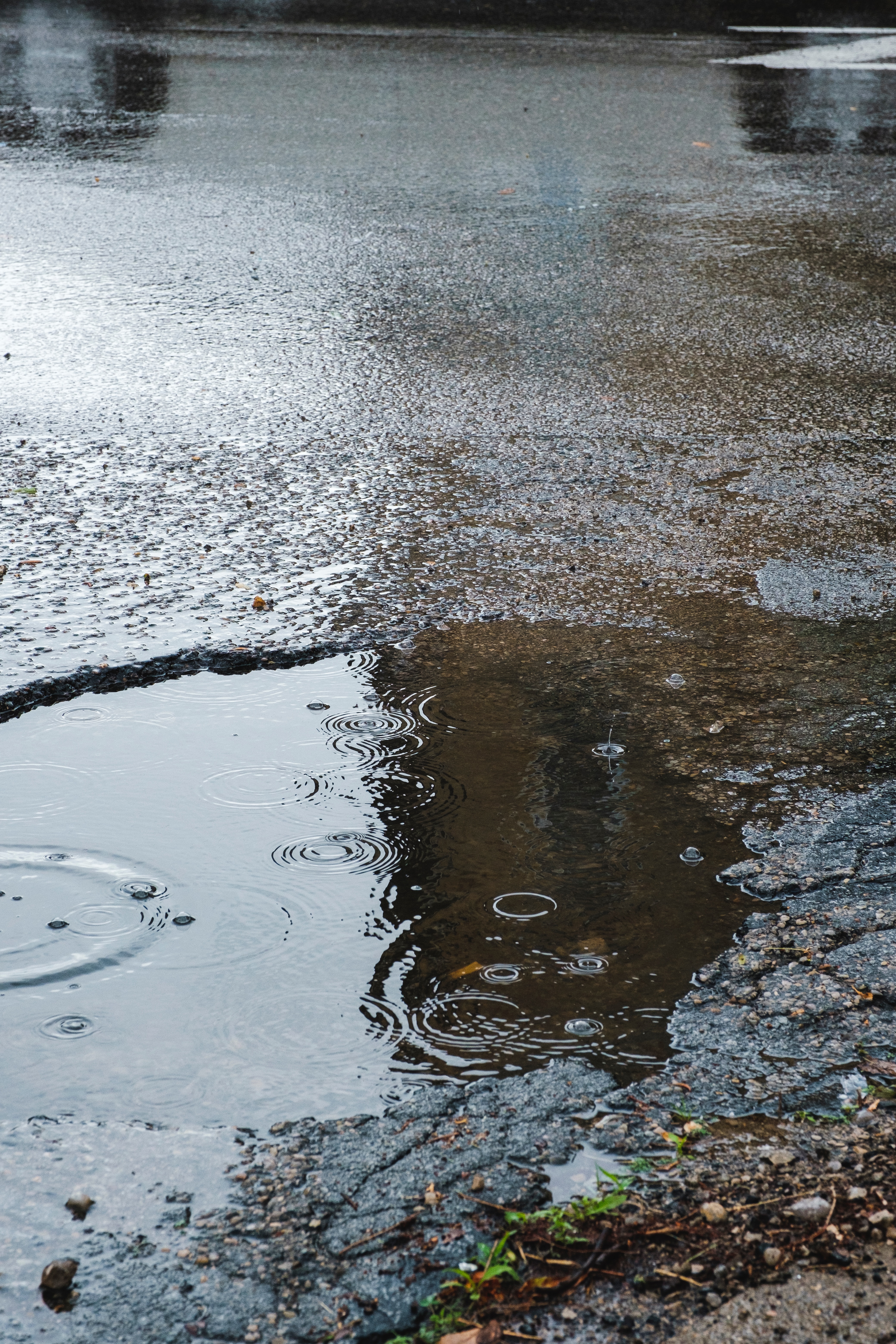 pothole filled with water in road