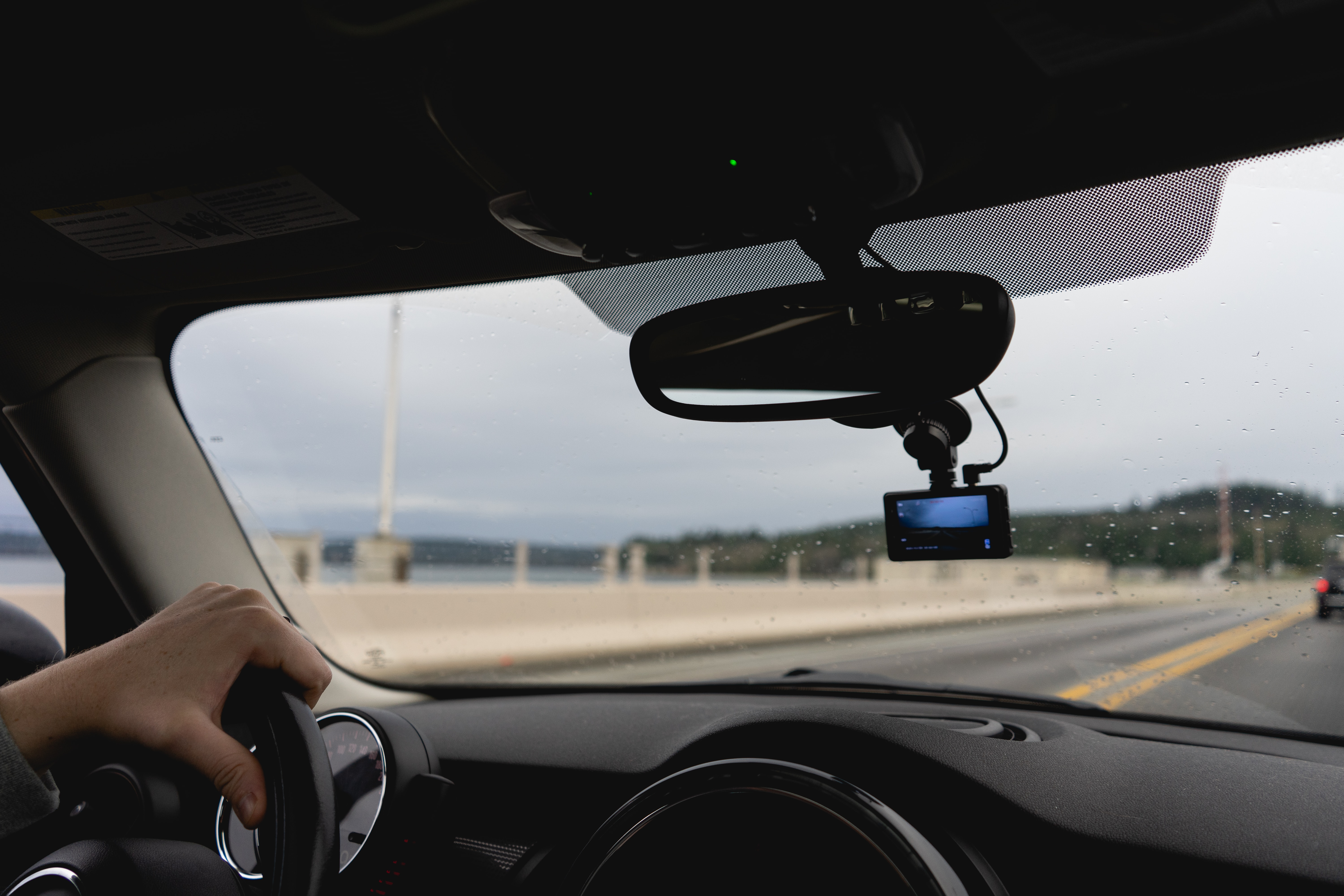 A person driving with a dashcam in their vehicle