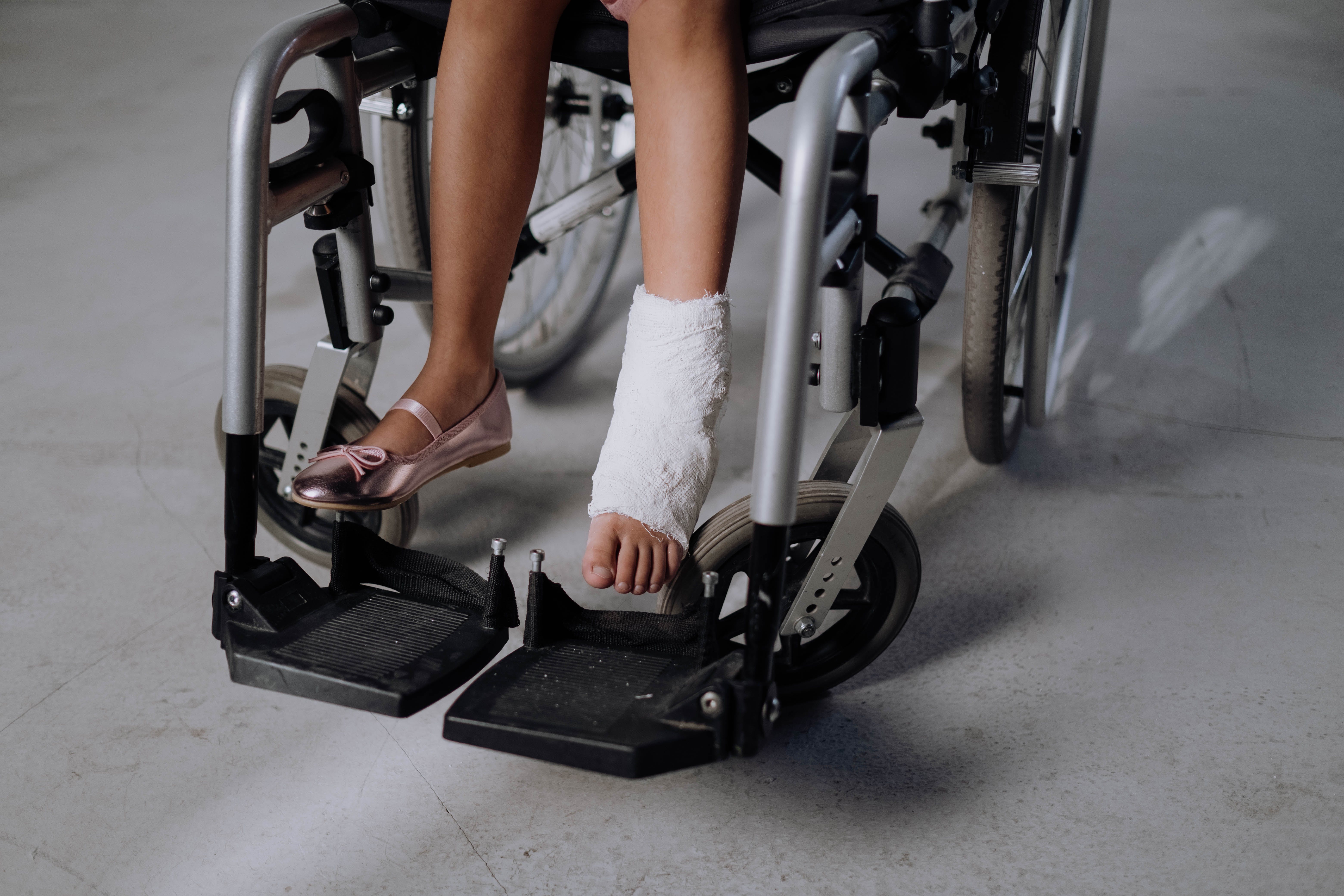 child in wheelchair with foot injury