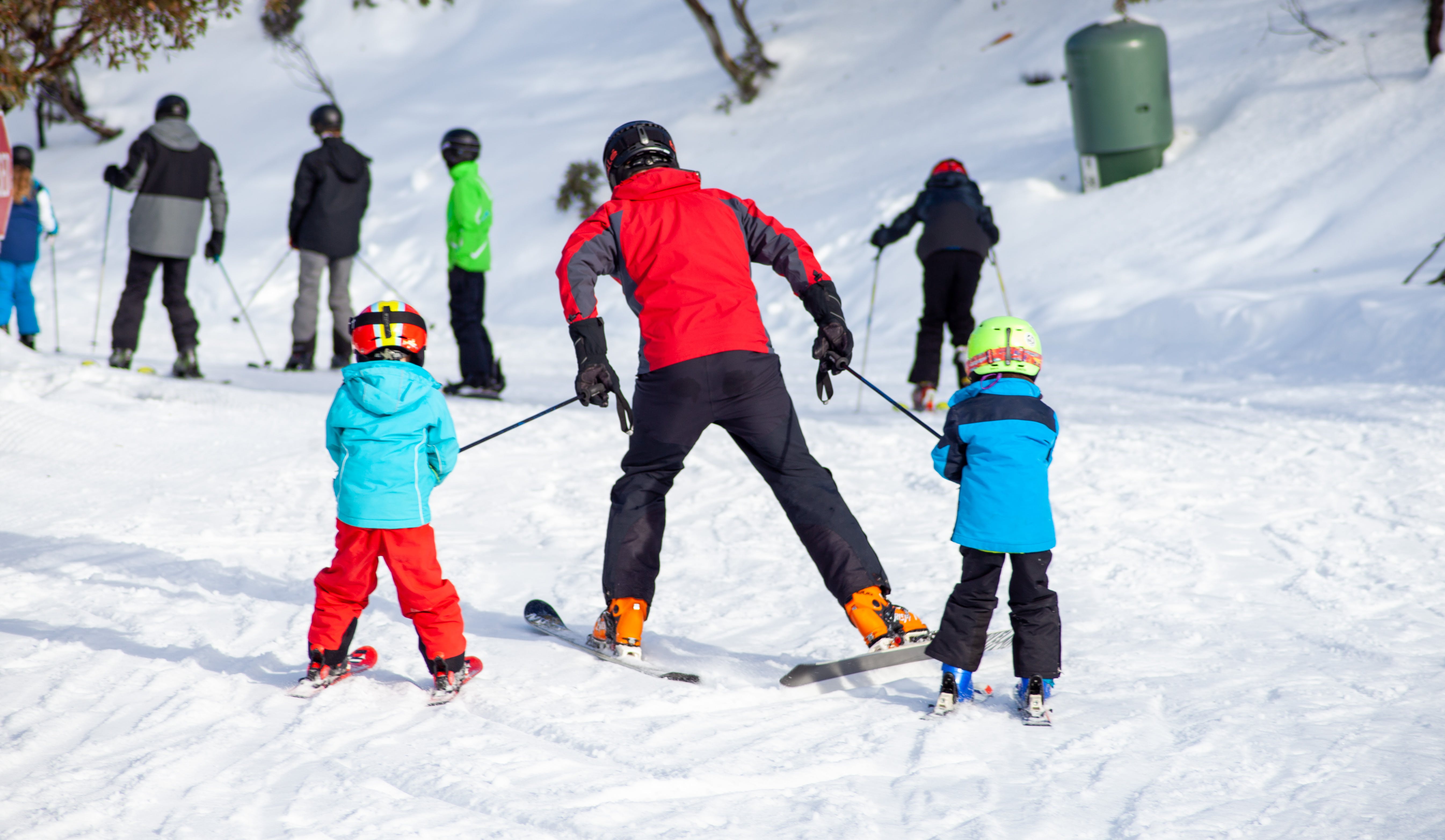 family skiing in snow