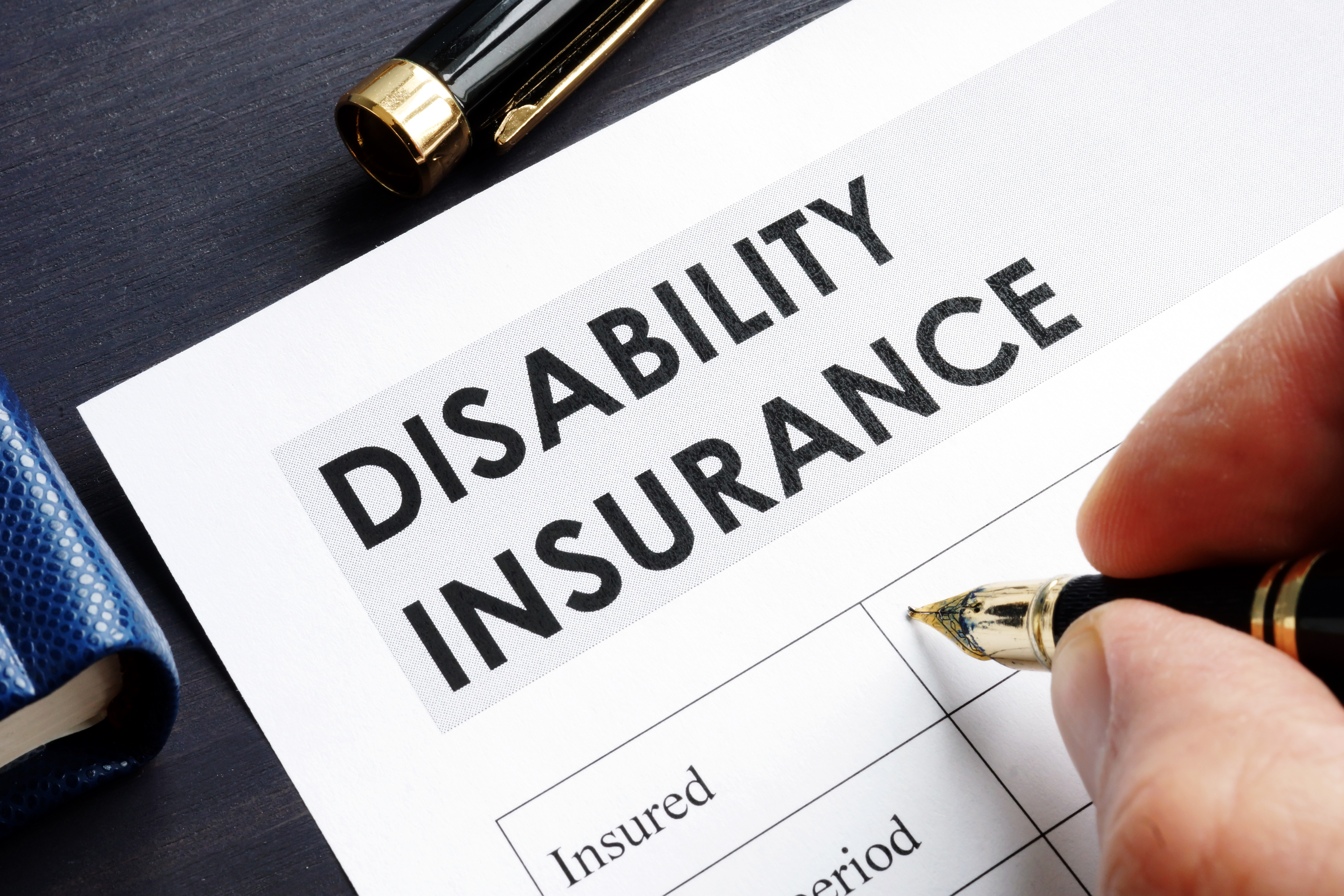 man filling disability insurance form