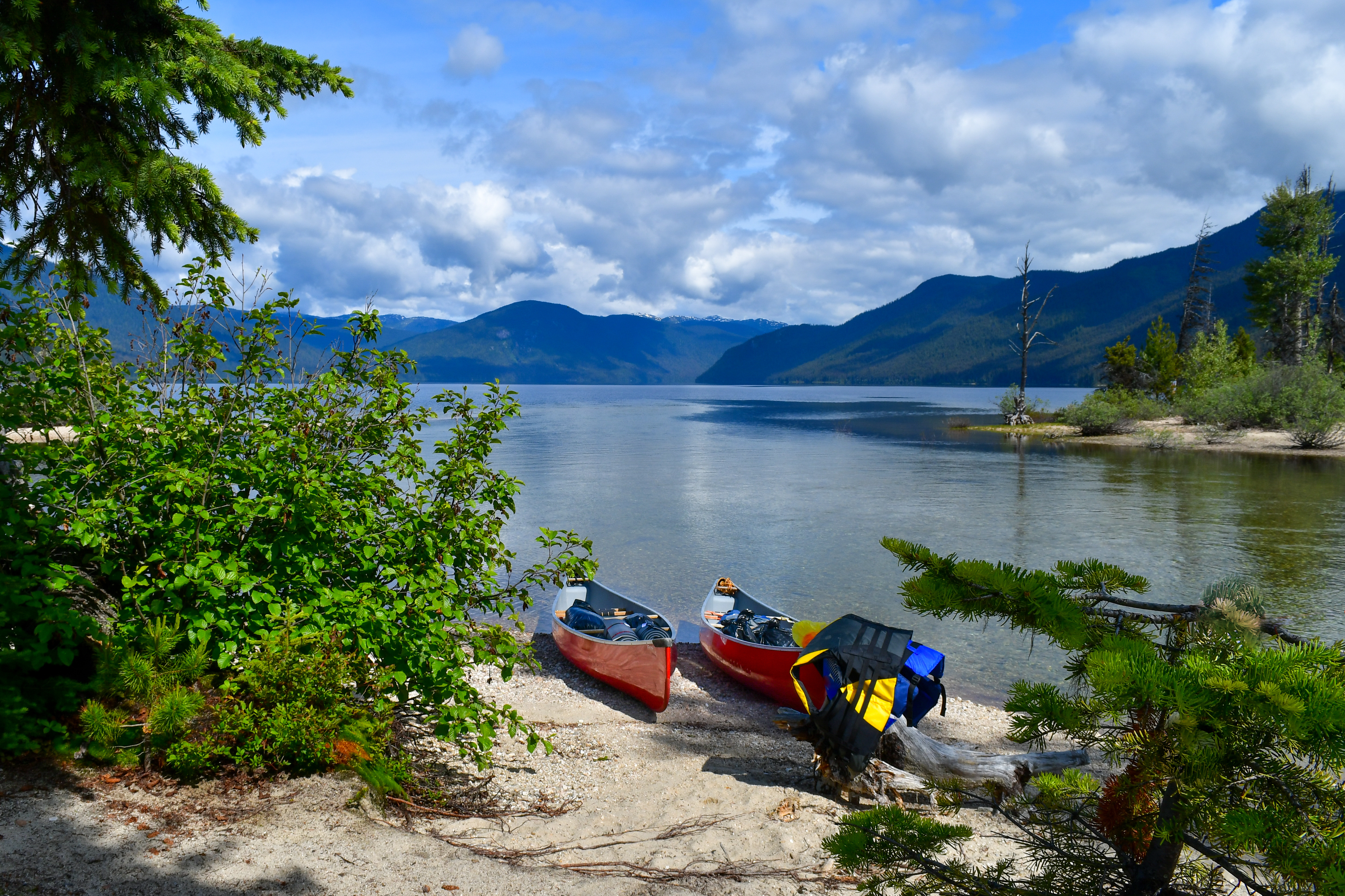 two canoes on shore of lake