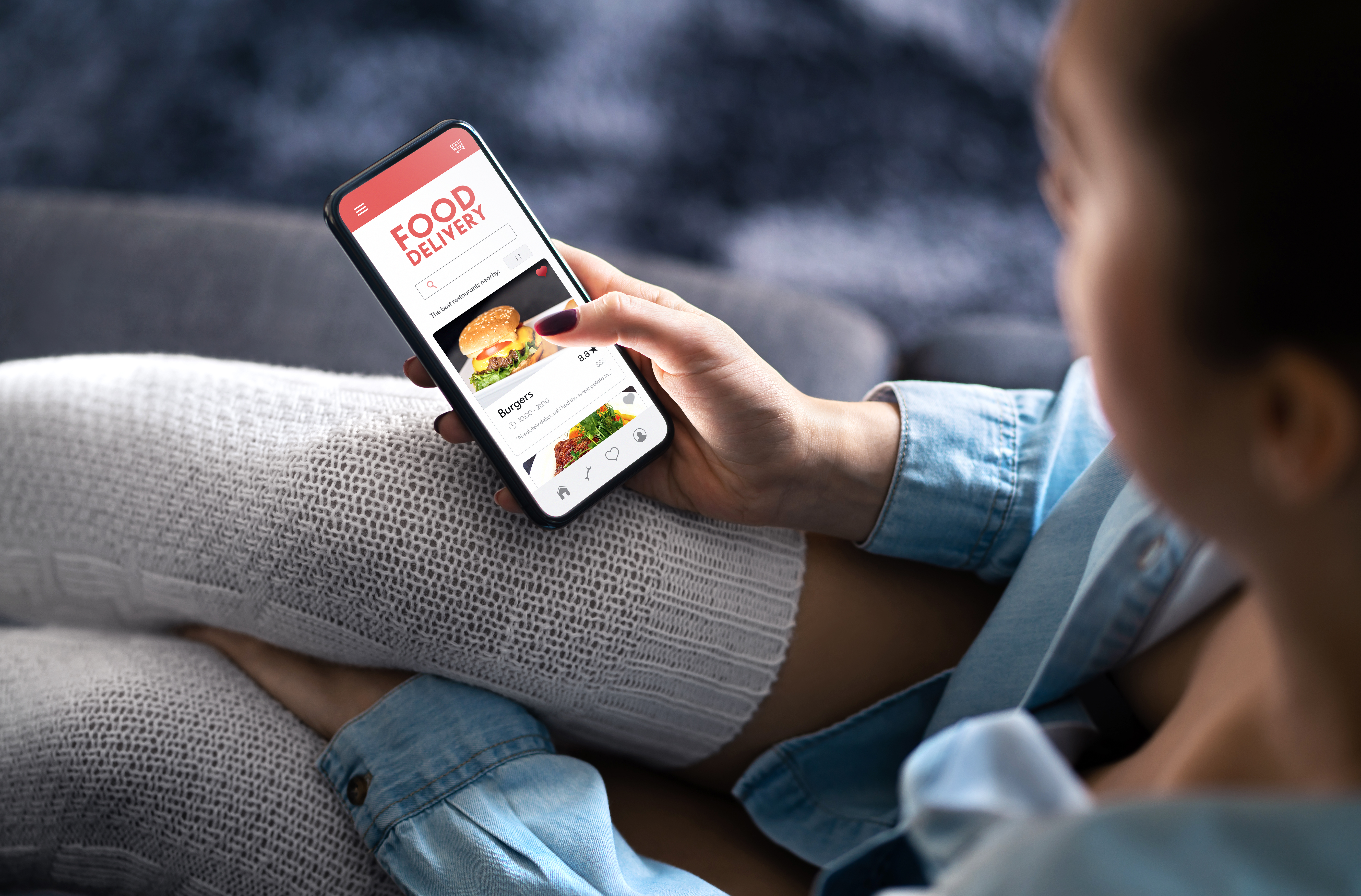 woman with phone on food delivery app