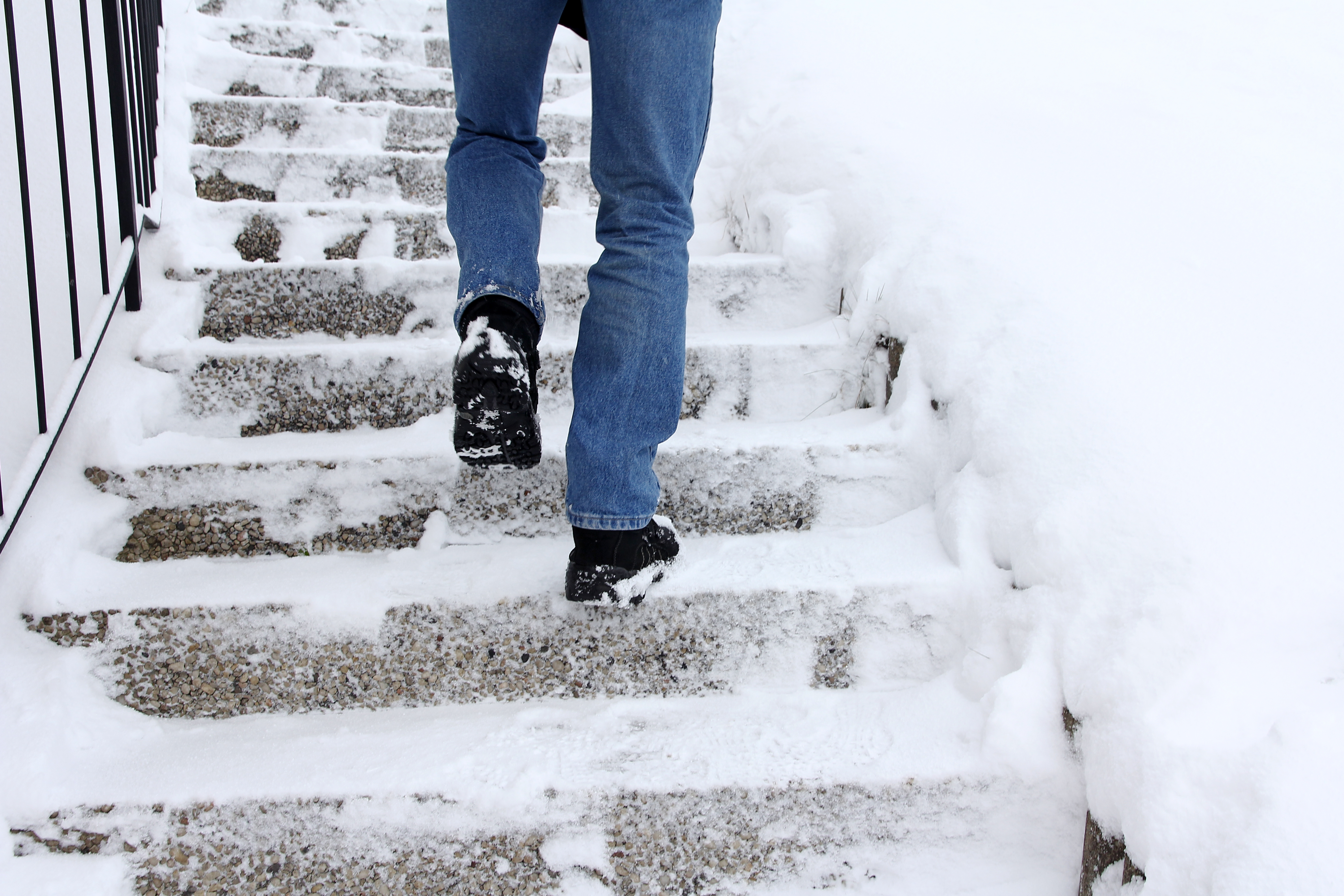 man walking to stairs in the snow