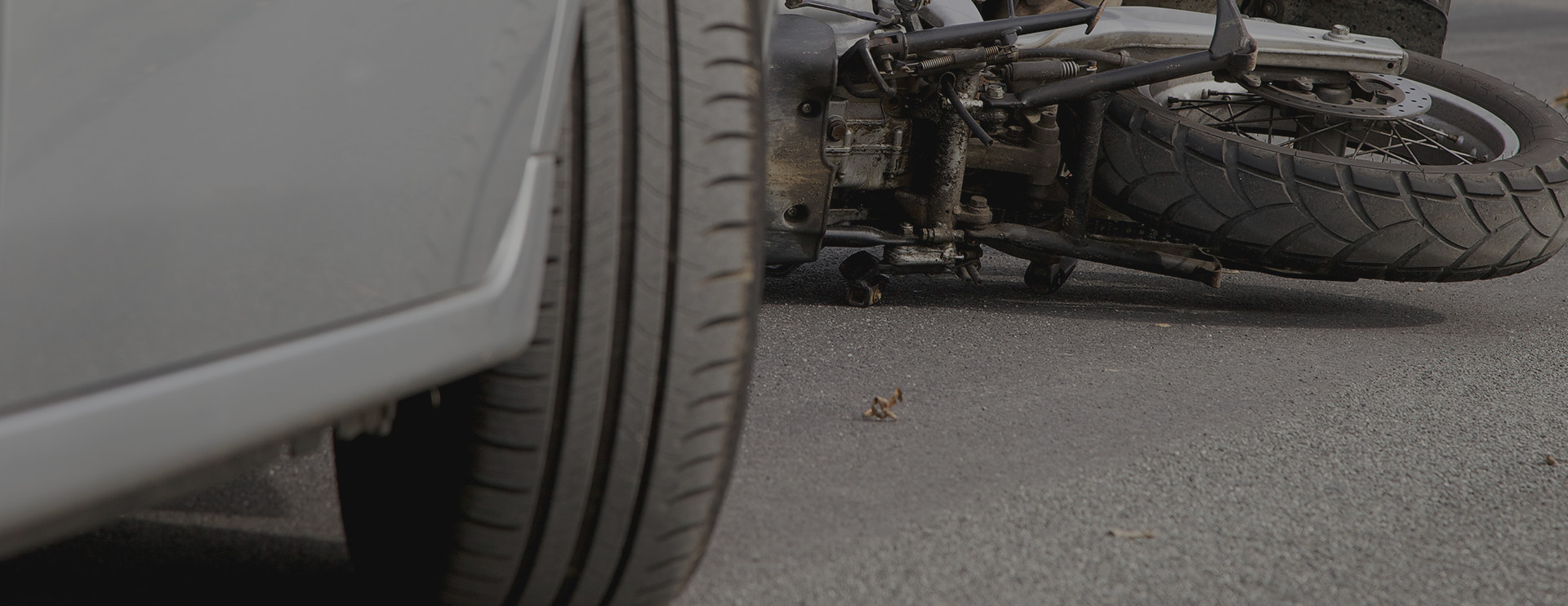 Car in front of a crashed motorcycle
